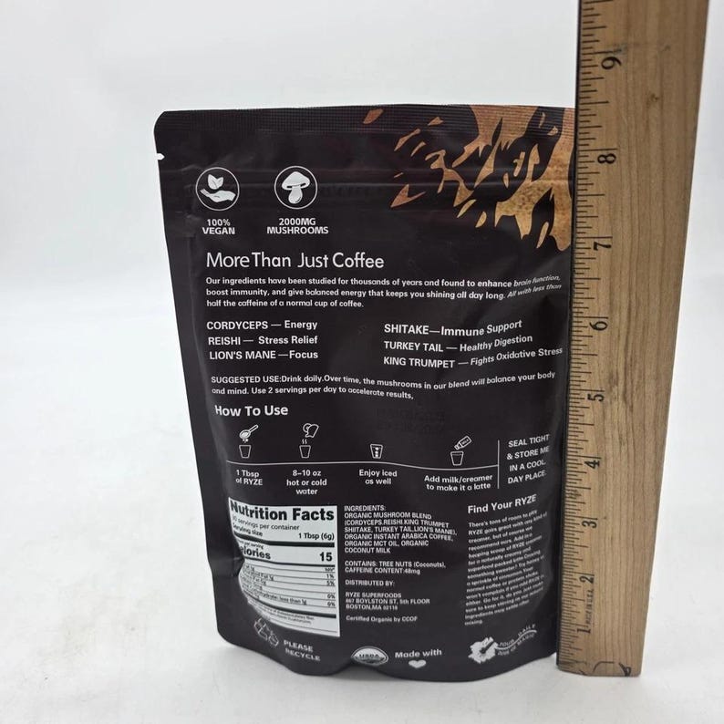 May include: A black pouch of "More Than Just Coffee" mushroom blend. The package includes text about the product's ingredients, benefits, and usage instructions. The package also includes nutritional information and is marked as vegan.