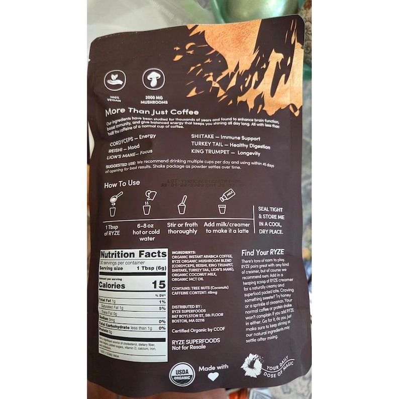 May include: A brown bag of RYZE mushroom coffee with text and graphics. The bag includes instructions, nutrition facts, and a list of ingredients. The product is USDA organic and contains 2000 mg of mushrooms.