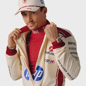 May include: A cream-colored baseball cap with a red Ferrari logo and blue HP branding, paired with a matching cream and red racing jacket featuring various sponsor logos including HP, UniCredit, Ceva Logistics, Bing, and Richard Mille text.