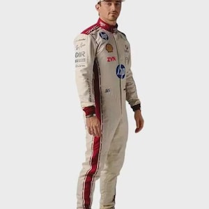 May include: A beige racing suit with dark red side stripes, featuring various sponsor logos including HP, Shell, and ZYN, paired with a matching beige baseball cap and white racing shoes with the number 16 printed on the side of the footwear.