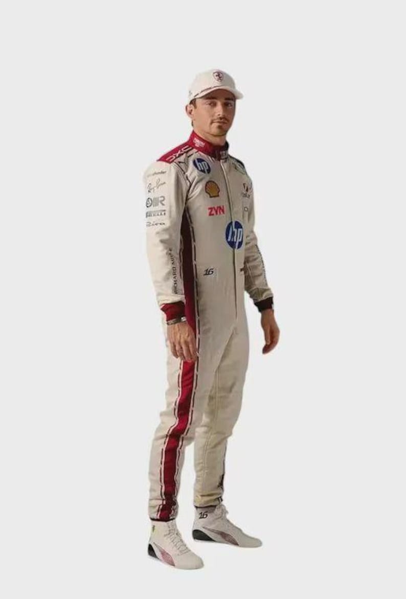 May include: A beige racing suit with dark red side stripes, featuring various sponsor logos including HP, Shell, and ZYN, paired with a matching beige baseball cap and white racing shoes with the number 16 printed on the side of the footwear.