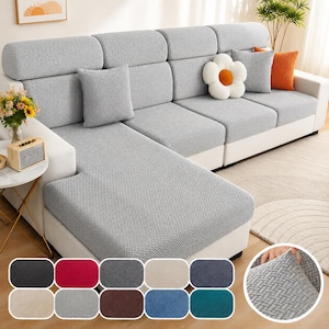 May include: A light gray sectional sofa with a textured fabric cover. The sofa has a white base and is accessorized with throw pillows in gray, orange, and a flower shape. A color swatch of available cover colors is shown.