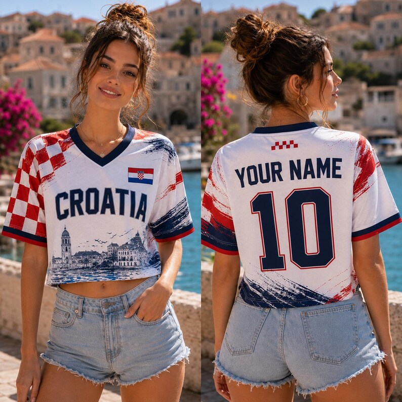 May include: A white V-neck crop top featuring a red and white checkered pattern on the left sleeve, the text CROATIA, a small Croatian flag, and a blue graphic of a coastal city. The back displays the text YOUR NAME and the number 10 in blue.