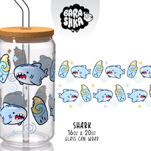 May include: A clear glass can-shaped cup with a bamboo lid and a black straw. The cup is decorated with a repeating pattern of cartoon sharks, waves, and stars. The text "Shark" and "Glass Can Wrap" are also visible.