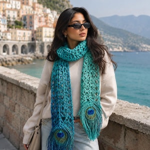 May include: A turquoise and teal crochet scarf with peacock feather accents. The scarf is worn around the neck and drapes down the front. The scarf is made of a soft, open-weave material. The peacock feather accents are at the bottom of the scarf.