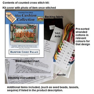 Contents of a counted cross stitch kit for a Hampton Court Palace mini cushion. The kit includes 14 count Aida fabric, DMC threads, a needle, backing fabric, a symbol chart, and instructions.