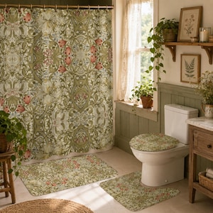 May include: A bathroom set featuring a shower curtain, a toilet seat cover, and two floor mats, all decorated with a repeating botanical pattern of green foliage, white flowers, and small red tulip-like buds on a light background.