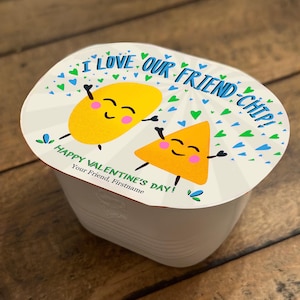 May include: A white oval container with a Valentine's Day themed design. The container features two cartoon chip characters with smiling faces and the text "I love our friend-chip! Happy Valentine's Day! Your Friend, Firstname".