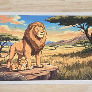 May include: A rectangular jigsaw puzzle featuring a colorful illustration of an adult lion standing on a rock with a small lion cub resting beside it. The background depicts a savanna landscape with acacia trees, tall grass, and distant hills.