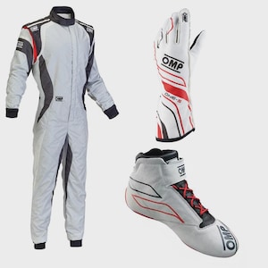 May include: A light gray OMP racing suit with black and red accents, a white OMP ONE-S racing glove with red and black detailing, and a light gray OMP racing shoe featuring red laces and black trim, all displayed against a plain background.