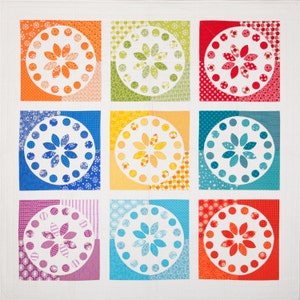 May include: Nine colorful squares with a white background, each containing a white circle with a stylized flower design. The squares are arranged in a 3x3 grid.