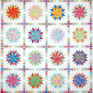 May include: A quilt with a white background and a repeating pattern of colorful star-shaped blocks. Each block has a different design and color scheme, including pink, blue, green, yellow, and red.