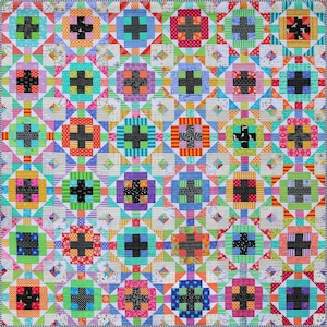 May include: A colorful patchwork quilt with a repeating pattern of plus signs within squares. The quilt features a variety of fabrics in bright colors like pink, green, blue, and orange. The border is a black and white striped pattern.