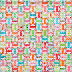 May include: A colorful quilt with a geometric pattern of squares, triangles, and rectangles. The quilt is made with a variety of fabrics in shades of pink, orange, green, blue, and white.