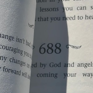 May include: Open book pages with text and numbers. The numbers 687, 688, and 689 are visible, along with text about talents, lessons, and change. Decorative wing-like flourishes are next to the numbers.
