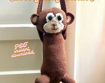 May include: A brown crocheted monkey grocery bag holder with a cream-colored face, large dark eyes, and a hanging strap. The text Grocery Bag Holder and PDF instant download are visible in a stylized orange font against the monkey figure.