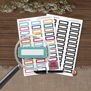 May include: Two sheets of rectangular scalloped stickers with a magnifying glass over one teal sticker. The sheets feature multi-colored and black labels with the text plannerloom.com, ID: LABEL-STANDARD-WARMRAINBOW-1-15, and SIZE OPTIONS AVAILABLE!.