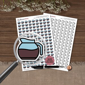 May include: Two sheets of planner stickers featuring rows of coffee pot icons. Each sticker shows a light blue top and dark brown bottom. A magnifying glass is positioned over one sticker, and a black pen and a US penny are placed nearby.