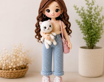 May include: A handmade crochet doll with long wavy brown hair, wearing a beige short-sleeved top, light blue cuffed jeans, and pink sneakers. The doll has gold hoop earrings, carries a small pink shoulder bag, and holds a white crochet cat.