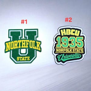 May include: Two embroidered patches. Patch #1 features a large green letter U with the yellow text NORTHFOLK STATE. Patch #2 is a shield shape with the yellow text HBCU 1935, white text NORFOLK STATE, and green text University on a black background.