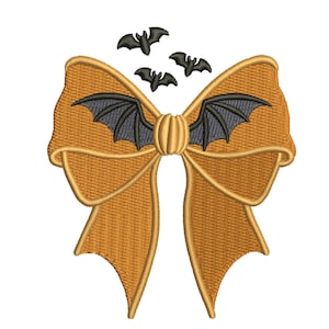 May include: An embroidered golden-orange bow featuring a central knot shaped like a pumpkin. Dark grey bat wings extend from the centre of the bow, and three small, dark grey embroidered bats are positioned above the bow on a white background.