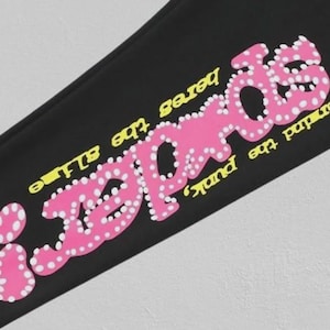 May include: Black fabric featuring the pink text "iRECORDS" in a bubble font, dotted with white circles. The text "never find the punk, heres the slime" is in yellow, following the angle of the main text.