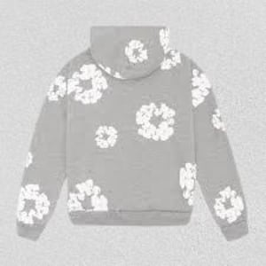 May include: A gray hoodie with a white floral pattern. The hoodie features a drawstring hood, long sleeves, and a ribbed hem and cuffs. The floral design is scattered across the front, back, and sleeves of the sweatshirt.