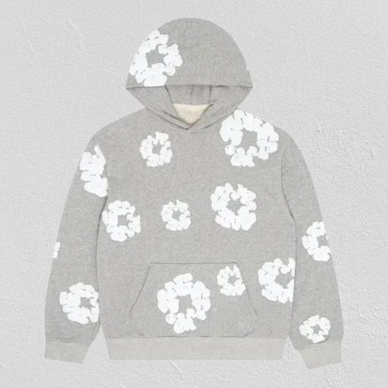 May include: A gray hoodie with a white floral pattern. The hoodie features a kangaroo pocket and a drawstring hood. The white floral design is repeated across the front, back, and sleeves of the sweatshirt. The hoodie is made of a soft, comfortable material.