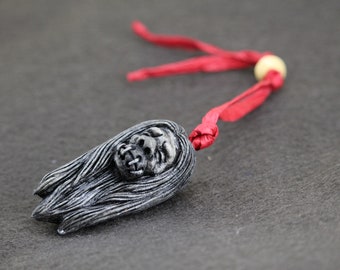 Ornamento de cabeza encogida