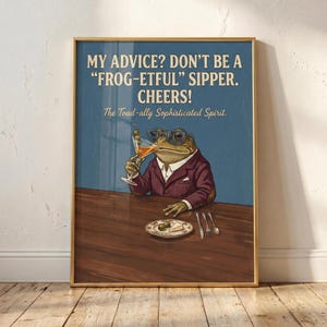 Può includere: Stampa incorniciata con un cartone animato di una rana in giacca e cravatta, con occhiali e un martini. La stampa ha il testo: "MY ADVICE? DON'T BE A 'FROG-ETFUL' SIPPER. CHEERS! The Toad-ally Sophisticated Spirit."