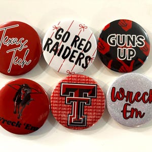 May include: A collection of six round buttons with various designs and text. The buttons feature the phrases "Texas Tech," "Go Red Raiders," and "Guns Up." Other buttons display a horse and the words "Wreck 'Em."