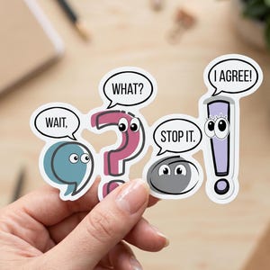 May include: A die-cut sticker featuring four animated punctuation marks with eyes and speech bubbles. A teal comma says WAIT, a pink question mark says WHAT?, a grey period says STOP IT., and a light purple exclamation point says I AGREE!.