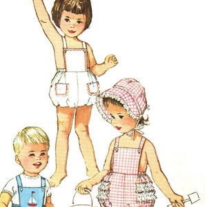 May include: Three children wearing summer outfits. A girl in a white and red gingham dress holds a bucket and shovel. A girl in a white and red gingham dress holds a bucket and shovel. A boy in a blue and white sailor-style outfit sits on the ground.