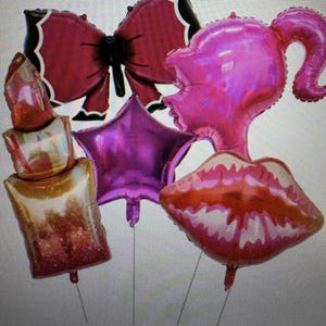 May include: A collection of foil balloons in various shapes, including a bow, a star, a lipstick, a woman's profile, and a pair of lips. The balloons are in shades of pink, red, and gold, with metallic finishes. Perfect for a party or celebration.