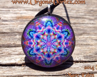 May include: A round, colorful pendant with a mandala design. The pendant is made of resin and features a variety of colors, including pink, blue, green, and purple. The pendant is hanging from a black cord.