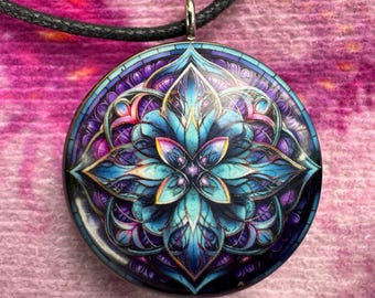 May include: A round pendant necklace with a black cord. The pendant features a colorful mandala design with blue, purple, and gold accents.