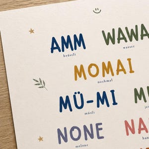 May include: A cream-colored poster featuring rows of colorful, bold, hand-lettered words including AMM, WAWA, MOMAI, M&Uuml;-MI, and NONE. Each word is paired with a smaller, simple text label underneath. Small decorative icons like stars, a leaf, and a smiley face are scattered across the page.