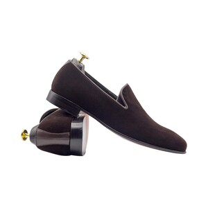 Pair of brown tassel loafers shown with a detailed view of the leather sole.
