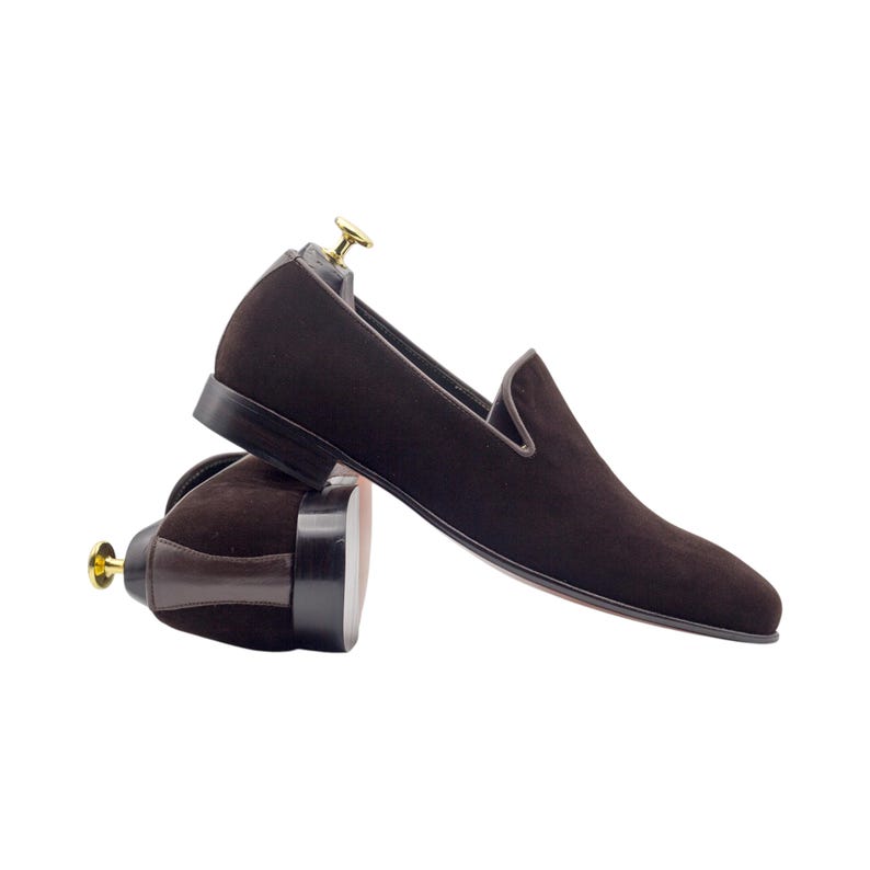 Pair of brown tassel loafers shown with a detailed view of the leather sole.