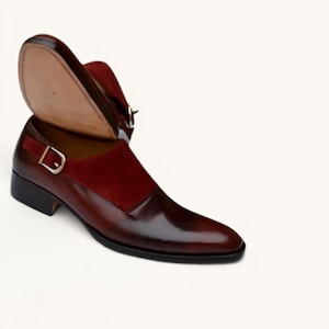 Side view of mens handmade burgundy leather dress shoes with a red suede panel and silver buckle.