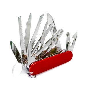 May include: A red multi-tool pocket knife with numerous stainless steel implements deployed, including a ruler, saw blade, scissors, pliers, and various screwdrivers. The tool features a bright red handle and a clear plastic magnifying glass attachment.