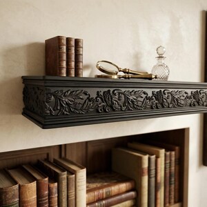 May include: A dark, intricately carved shelf displaying books, a magnifying glass, and a small glass bottle. The shelf, with its detailed floral and face motifs, is mounted on a wall above a bookcase filled with books.