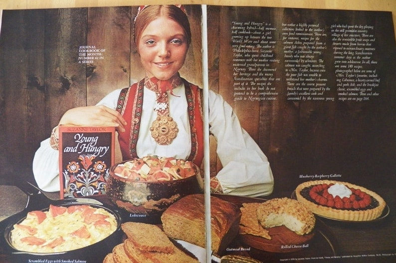 May include: An advertisement for a cookbook titled "Young and Hungry" featuring a woman in traditional Norwegian attire. The image showcases various dishes, including scrambled eggs with smoked salmon, bread, and a berry tart.