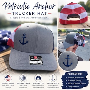 May include: A grey trucker hat featuring a dark blue embroidered anchor on the front panel. The hat includes a red, white, and blue mesh back with a star pattern and an adjustable snapback closure. A Richardson 112 sticker is on the brim.