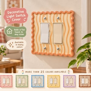 May include: A double light switch cover with a wavy, scalloped orange border and a cream-colored center featuring vertical orange wavy lines. The cover is secured with four silver screws. Below, six additional color variations are displayed.