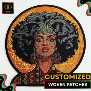 May include: A circular woven patch with a portrait of a woman with an afro, tribal face paint, and earrings. The patch has a black background and the text "CUSTOMIZED WOVEN PATCHES". The design is framed by an orange border with a decorative pattern.