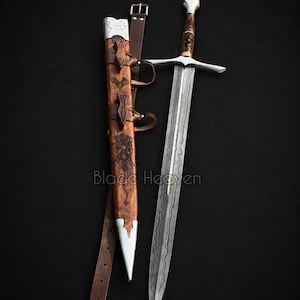 May include: A steel sword with a patterned blade and a detailed hilt, accompanied by a wooden scabbard featuring metal accents and a brown leather belt. The scabbard displays intricate carvings and the text Blade Heaven is visible on the image.