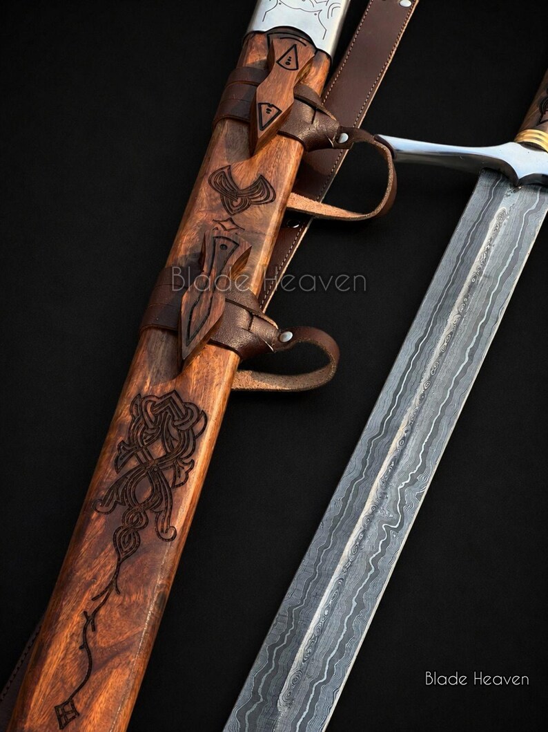 May include: A sword with a patterned Damascus steel blade and a wooden scabbard featuring intricate carvings and leather straps. The text Blade Heaven is visible on the scabbard and the lower right corner. The hilt has a silver crossguard.