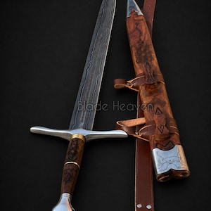 May include: A double-edged sword with a patterned Damascus steel blade, a wooden handle with metal accents, and a matching wooden scabbard featuring metal fittings and a brown leather belt. The text Blade Heaven is visible on the image.
