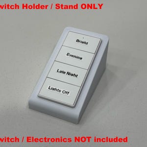May include: A white switch holder with four labeled buttons: Bright, Evening, Late Night, and Lights Off. The stand is angled for easy viewing and use. The text "Switch Holder / Stand ONLY" is at the top.